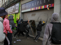 Demonstrators clash with riot police following a May Day march in Santiago on May 1, 2018. ( (