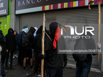 Demonstrators clash with riot police following a May Day march in Santiago on May 1, 2018. (. (