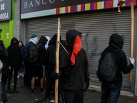 Demonstrators clash with riot police following a May Day march in Santiago on May 1, 2018. (. (