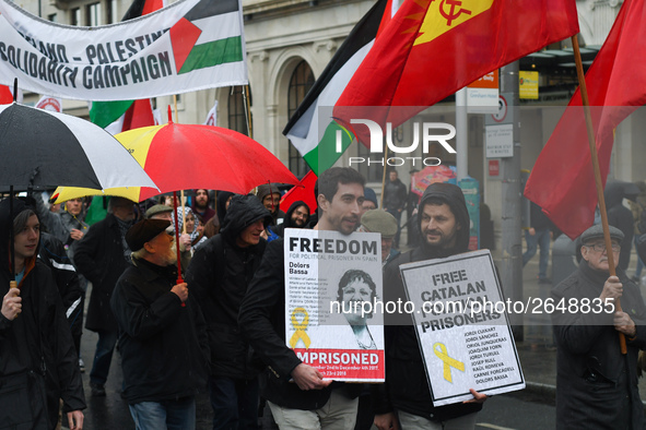 Two men hold 'Free Catalan Political Prisoners' sign as they joing hundreds of people including SIPTU unions, Right2Work campaigners, member...