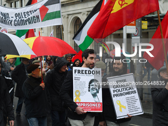 Two men hold 'Free Catalan Political Prisoners' sign as they joing hundreds of people including SIPTU unions, Right2Work campaigners, member...