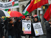 Two men hold 'Free Catalan Political Prisoners' sign as they joing hundreds of people including SIPTU unions, Right2Work campaigners, member...