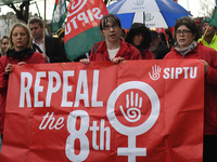 Members of SIPTU union hold 'Repeal the 8th' banner as they join hundreds of people including SIPTU unions, Right2Work campaigners, members...