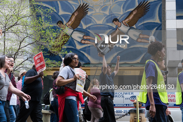 Demonstrators march towards the Thompson Center for May Day, also known as International Workers’ Day, in Chicago on May 1, 2018. 