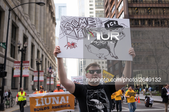 A demonstrator marches towards Immigration and Customs Enforcement's (ICE) Chicago headquarters for May Day, also known as International Wor...