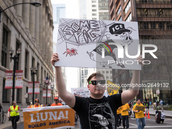 A demonstrator marches towards Immigration and Customs Enforcement's (ICE) Chicago headquarters for May Day, also known as International Wor...