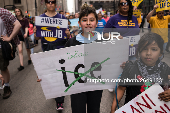 Young demonstrators display their placards as they march towards Immigration and Customs Enforcement's (ICE) Chicago headquarters for May Da...