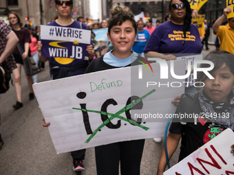 Young demonstrators display their placards as they march towards Immigration and Customs Enforcement's (ICE) Chicago headquarters for May Da...