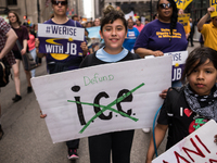 Young demonstrators display their placards as they march towards Immigration and Customs Enforcement's (ICE) Chicago headquarters for May Da...