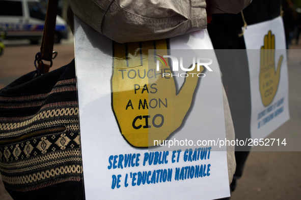 A placard reading 'Don't touch my CIO, public and free services for education' as Macron plans their closures. CIO is the ancronym for Cente...