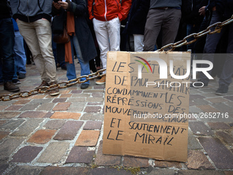 A cardboard reading 'Students from Paul Sabatier University condemn repression of social movements and support Le Mirail university'. Severa...