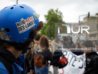 A demonstrator wears an helmet with a sticker reading 'Notre rêve des Landes'. Several sectors on strike called to a protest and a gathering...