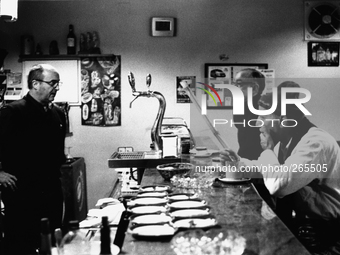 Alfonso and Fernando, pilgrims traveling to Santiago de Compostela, in a breakfast bar, in Roncesvalles, Spain, on December 2004  (