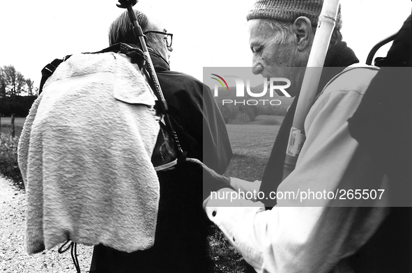 Venezuelan pilgrims Fernando and Alfonso settle the backpack on the way, in Burguete, Spain, December 2004 
 