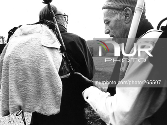 Venezuelan pilgrims Fernando and Alfonso settle the backpack on the way, in Burguete, Spain, December 2004 
 (