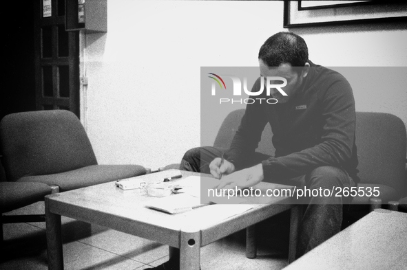 Borja, pilgrim cyclist, plans the route for the next day, at the hostel, in Laransoana, Spain, on December 2004 