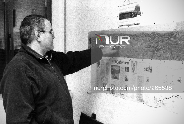 Juan, Spanish pilgrim  studying the map of the path shown in the living room of the hostel, in Laransoana, Spain, on December 2004 