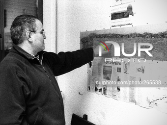 Juan, Spanish pilgrim  studying the map of the path shown in the living room of the hostel, in Laransoana, Spain, on December 2004 (