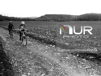 Two cyclists pilgrims on the journey to Santiago de Compostela running to Alto del Perdòn, in Zariquiegui, Spain, on December 2004  (