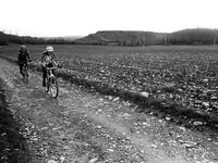 Two cyclists pilgrims on the journey to Santiago de Compostela running to Alto del Perdòn, in Zariquiegui, Spain, on December 2004  (