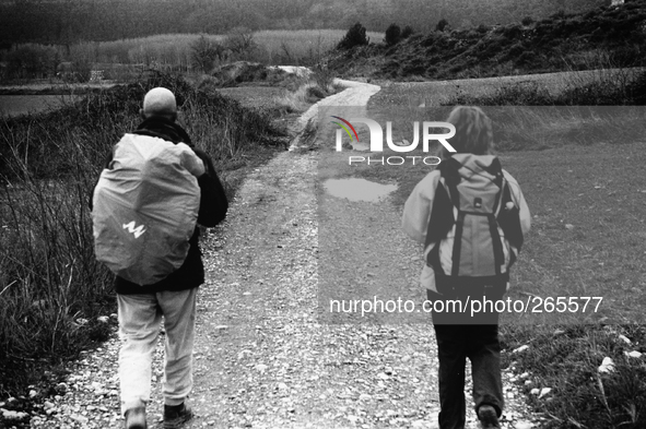 Two pilgrims crossing the hilly countryside between Ciraqui and Estella, in Lorca, Spain, on December 2004  