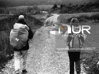 Two pilgrims crossing the hilly countryside between Ciraqui and Estella, in Lorca, Spain, on December 2004  (