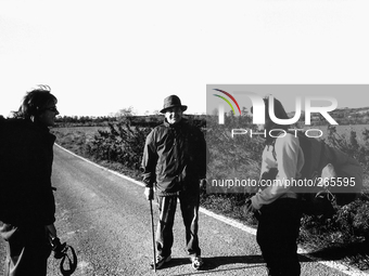 Two pilgrims asking for information on the path of the road to Santiago because of a long detour on the highway, near Torres del Rio, Spain,...