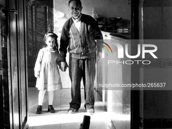 Grandfather and granddaughter in their small bar-tavern, in Espinosa del Camino, Spain, on December 2004  (