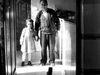 Grandfather and granddaughter in their small bar-tavern, in Espinosa del Camino, Spain, on December 2004  (