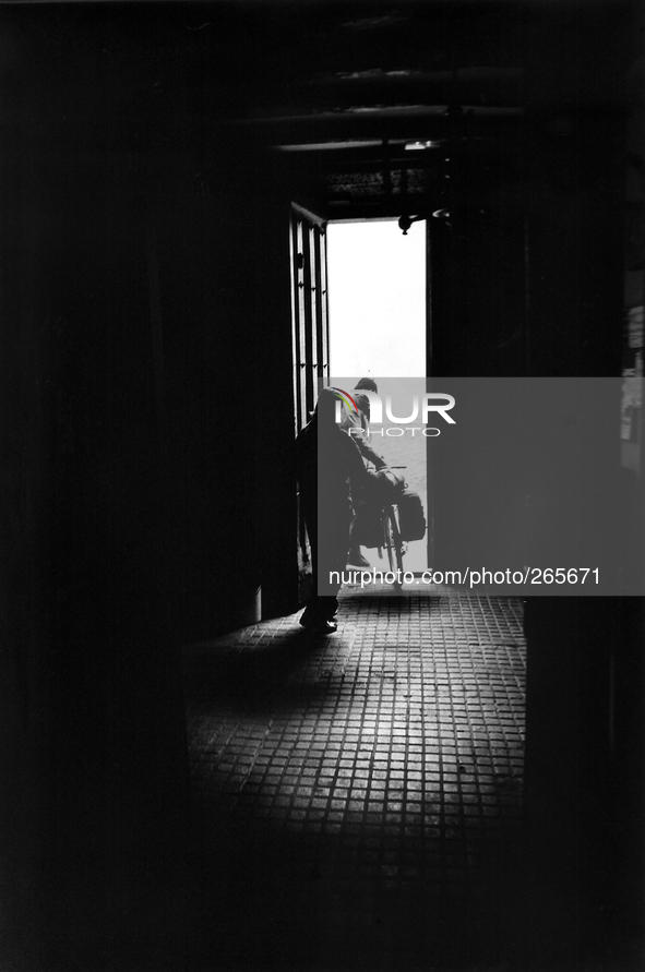 A pilgrim cyclist starts from the shelter in the early morning, in Astorga, Spain, on December 2004 