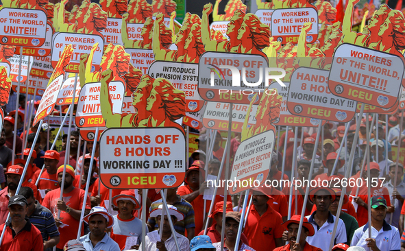 Supporters of Sri Lankan Marxist political party, People's Liberation Front, shout slogans holding placards during a parade march held to ma...