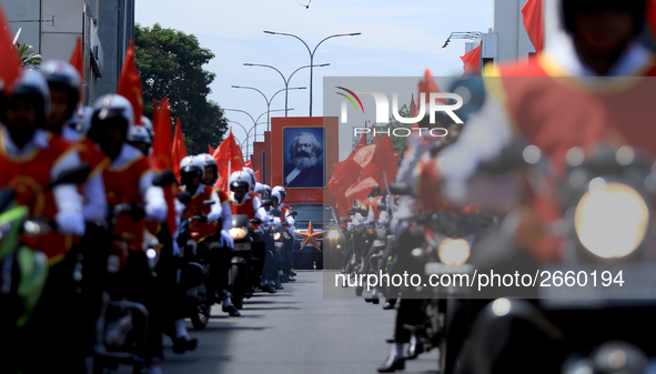 A portrait of German socialist Karl Marx is seen as Supporters of Sri Lankan Marxist political party, People's Liberation Front, ride bikes...