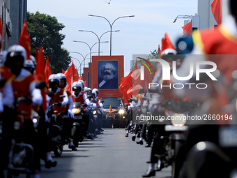 A portrait of German socialist Karl Marx is seen as Supporters of Sri Lankan Marxist political party, People's Liberation Front, ride bikes...