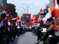 A portrait of German socialist Karl Marx is seen as Supporters of Sri Lankan Marxist political party, People's Liberation Front, ride bikes...