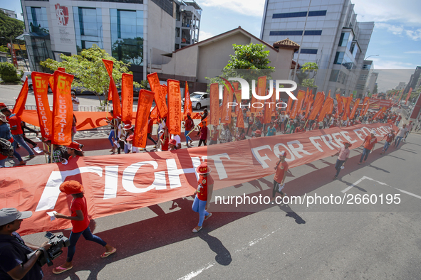 Supporters of Sri Lankan Marxist political party, People's Liberation Front, shout slogans while holding flags during a parade march held to...