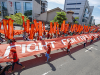 Supporters of Sri Lankan Marxist political party, People's Liberation Front, shout slogans while holding flags during a parade march held to...