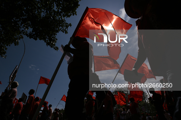 Supporters of Sri Lankan Marxist political party, People's Liberation Front, shout slogans while holding flags during a parade march held to...