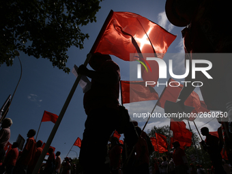 Supporters of Sri Lankan Marxist political party, People's Liberation Front, shout slogans while holding flags during a parade march held to...