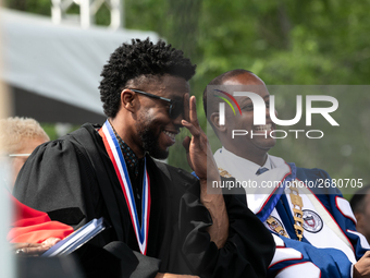 (L-R): Actor and alumnus Chadwick Boseman, and Howard University President Dr. Wayne A.I. Frederick share a laugh at the commencement ceremo...