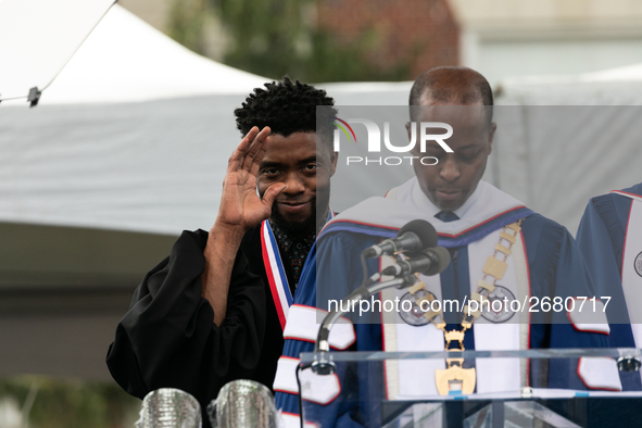 (L-R): Actor and alumnus Chadwick Boseman listens to Howard University President Dr. Wayne A.I. Frederick read his bio, at the commencement...