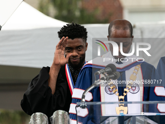 (L-R): Actor and alumnus Chadwick Boseman listens to Howard University President Dr. Wayne A.I. Frederick read his bio, at the commencement...