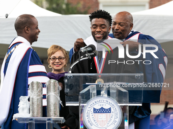 Actor and alumnus Chadwick Boseman (center), participates in a hooding receiving an honorary degree, Doctor of Humane Letters. as Howard Uni...