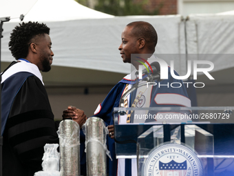 (L-R): Actor and alumnus Chadwick Boseman shakes hands with Howard University President Dr. Wayne A.I. Frederick, at the commencement ceremo...