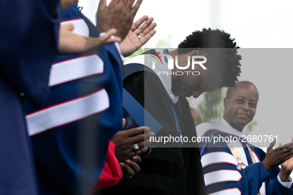 Actor and alumnus Chadwick Boseman (2nd right), after he delivered the keynote address at Howard University's commencement ceremony for the...