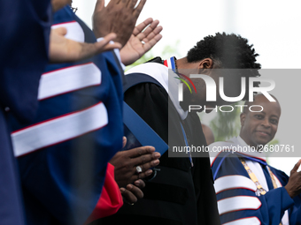 Actor and alumnus Chadwick Boseman (2nd right), after he delivered the keynote address at Howard University's commencement ceremony for the...