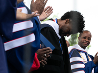 Actor and alumnus Chadwick Boseman (2nd right), after he delivered the keynote address at Howard University's commencement ceremony for the...