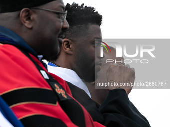 Actor and alumnus Chadwick Boseman (2nd right), after he delivered the keynote address at Howard University's commencement ceremony for the...