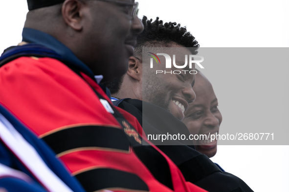 Actor and alumnus Chadwick Boseman (2nd right), shares a laugh with Howard University President Wayne A. I. Frederick (R), after he delivere...