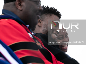 Actor and alumnus Chadwick Boseman (2nd right), shares a laugh with Howard University President Wayne A. I. Frederick (R), after he delivere...