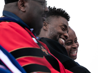 Actor and alumnus Chadwick Boseman (2nd right), shares a laugh with Howard University President Wayne A. I. Frederick (R), after he delivere...